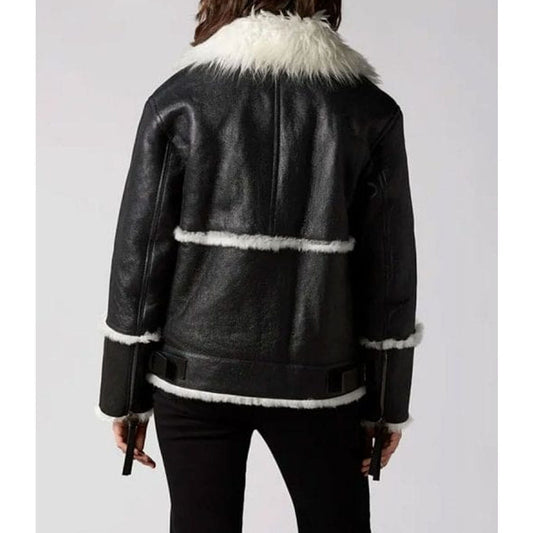 A black leather aviator-style jacket with white shearling trim, shown from the back on a model against a light gray background.