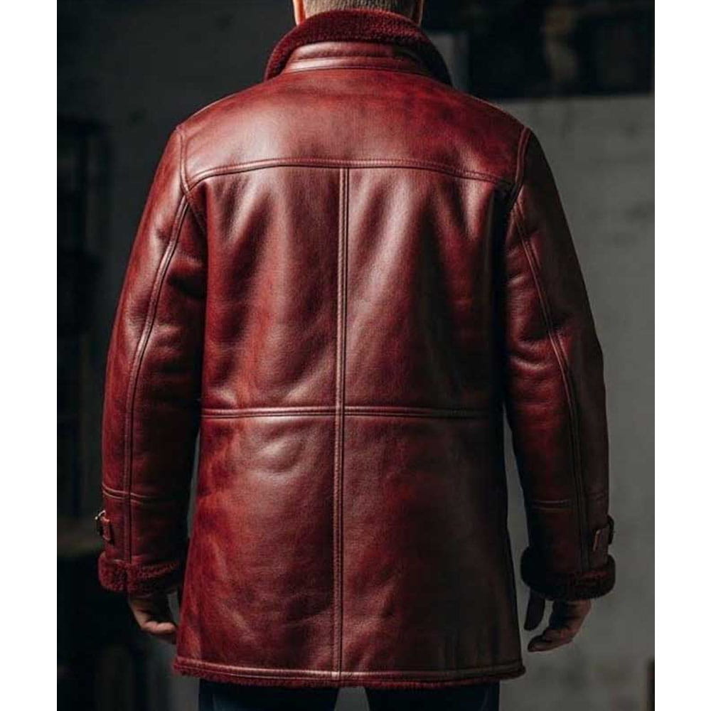 A person viewed from the back wearing a dark reddish-brown leather jacket with a high collar and visible seam paneling, against a dim indoor background.