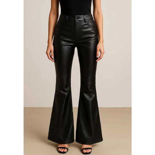 A model wearing black high-waisted faux leather flare pants, paired with a black top and black sandals, standing against a neutral beige studio background.