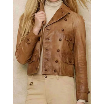 A cropped tan leather jacket with double-breasted buttons, worn by a model over a cream turtleneck and beige pants.