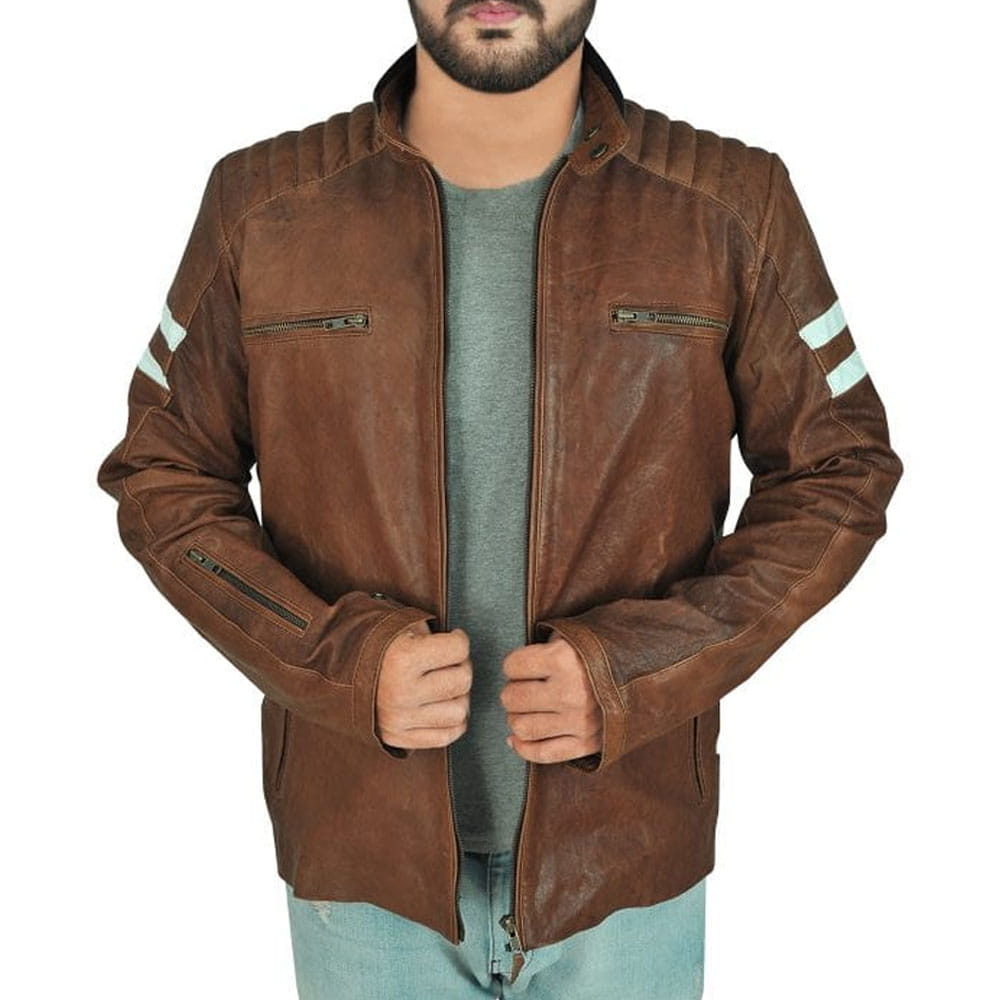 A man wearing a brown distressed leather motorcycle jacket with light blue jeans and a gray t-shirt, shown from the chin down against a white background.