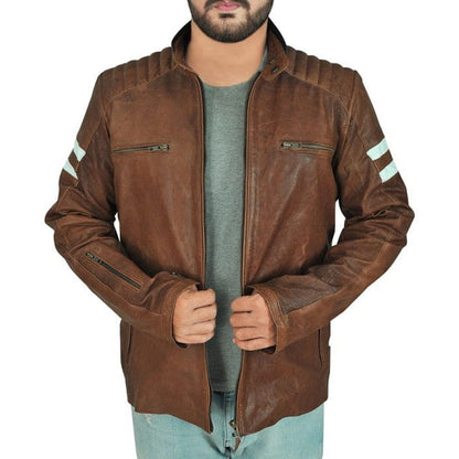 A man wearing a brown distressed leather motorcycle jacket with light blue jeans and a gray t-shirt, shown from the chin down against a white background.
