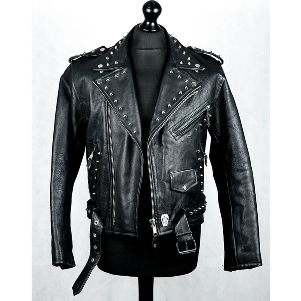 Black leather motorcycle jacket with silver studs and a skull buckle detail, displayed on a black mannequin torso against a light gray background.