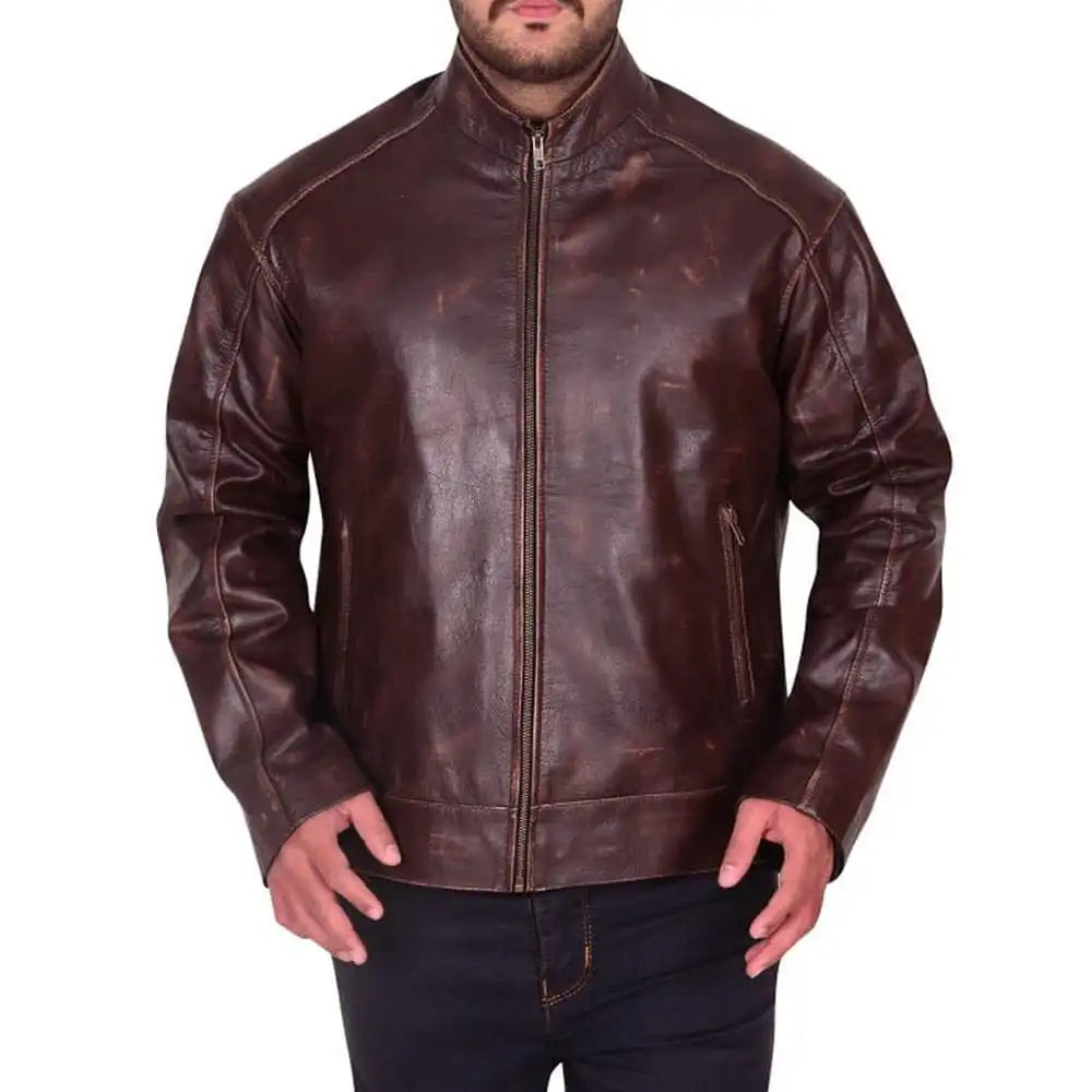 A man wearing a dark brown distressed leather jacket with a full-zip front and stand-up collar, paired with dark jeans, shown against a plain white background.