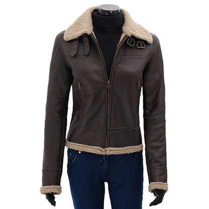 A dark brown leather aviator-style jacket with a beige shearling collar, hem, and cuffs, displayed on a black mannequin torso wearing blue jeans and black gloves against a white background.