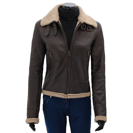 A dark brown leather aviator-style jacket with a beige shearling collar, hem, and cuffs, displayed on a black mannequin torso wearing blue jeans and black gloves against a white background.