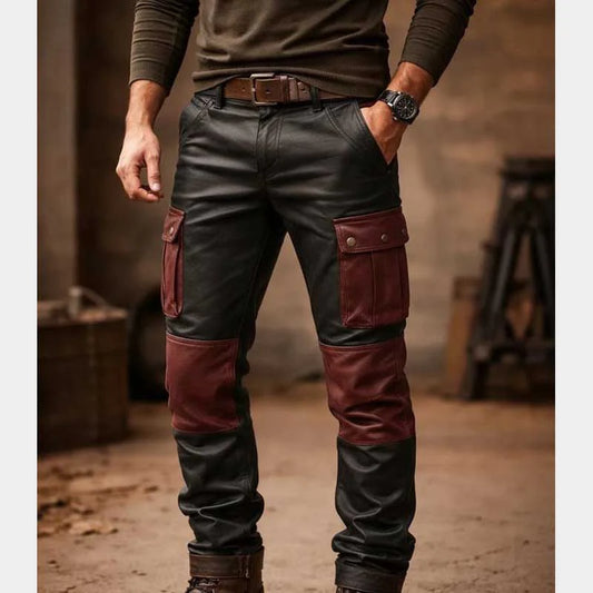 Person wearing dark leather pants with red accents in a rustic setting