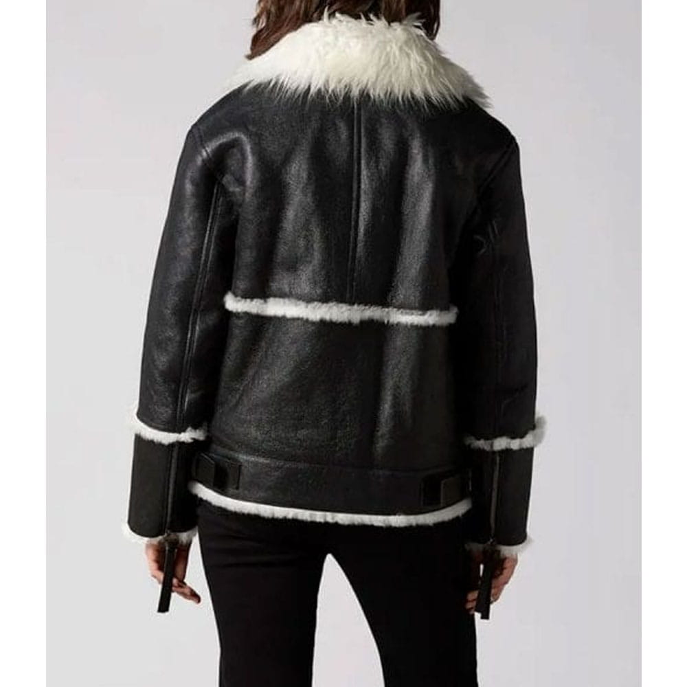 A black leather aviator-style jacket with white shearling trim, shown from the back on a model against a light gray background.
