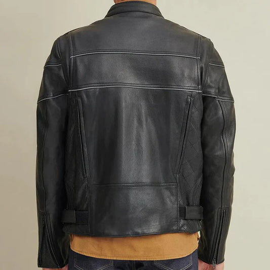 A black leather motorcycle jacket shown from the back, worn by a model. The jacket features contrast white stitching, zippered pockets, and quilted sleeve panels, layered over a tan shirt and blue jeans against a plain beige background.
