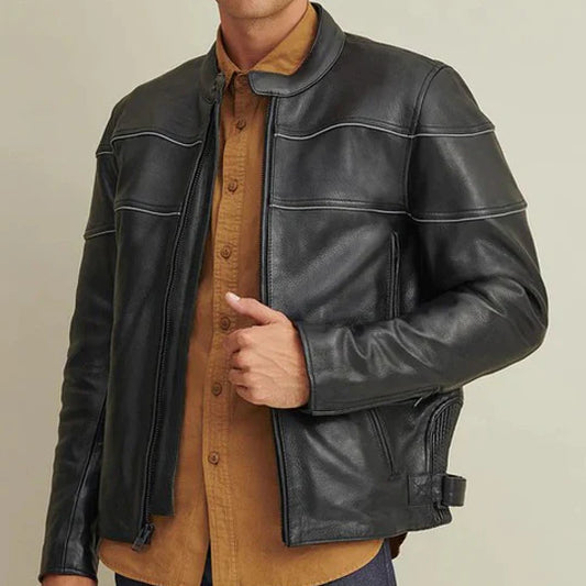 Person wearing a black leather jacket over a brown shirt on a beige background