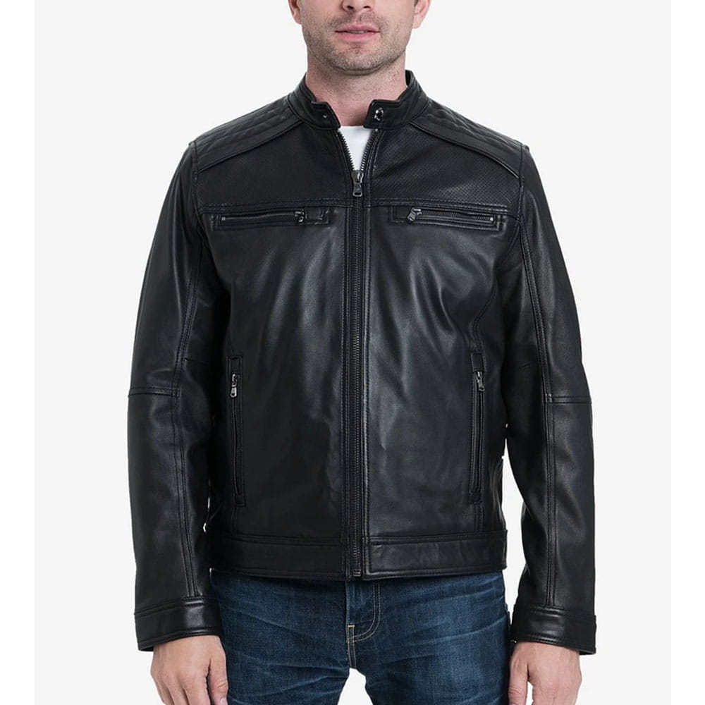 A man wearing a black leather motorcycle jacket with zippered chest pockets and a front zipper, paired with blue jeans, against a light gray background.