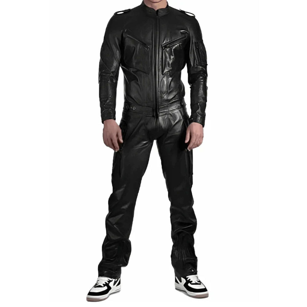 A man wearing a black leather motorcycle jacket and matching black leather pants, standing against a plain white background.