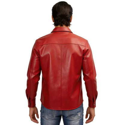 A man viewed from the back wearing a bright red leather jacket and blue jeans against a plain white background.