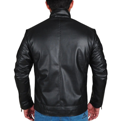 A man viewed from the back wearing a black faux-leather biker jacket, paired with blue jeans, against a plain white background.