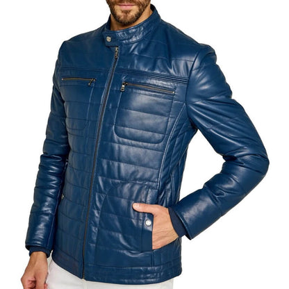 A man wearing a navy blue quilted faux-leather jacket with a stand-up collar, front zipper, and zippered chest pockets, shown against a plain white background.