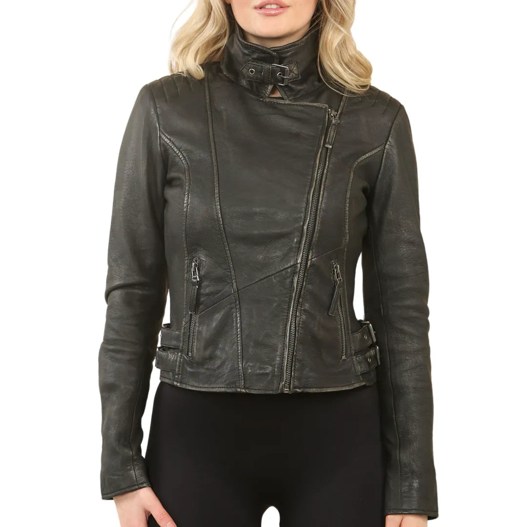 A woman wearing a black distressed leather motorcycle jacket with a high mock neck and asymmetrical zipper, paired with black pants, against a plain white background.