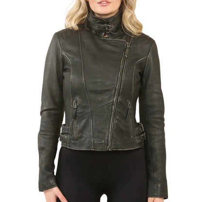A woman wearing a black distressed leather motorcycle jacket with a high mock neck and asymmetrical zipper, paired with black pants, against a plain white background.