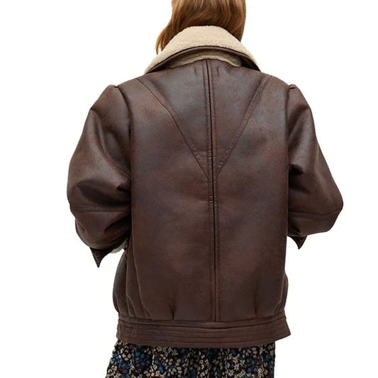 A person viewed from the back wearing a dark brown faux-leather jacket with a beige sherpa collar, set against a plain white background.