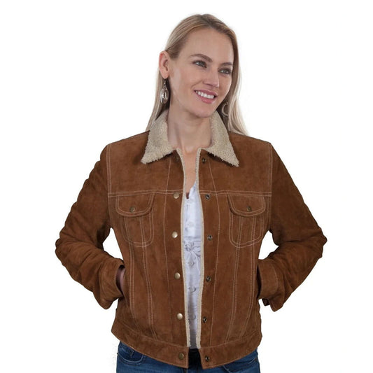 A woman wearing a brown suede jacket with a beige sherpa collar, styled over a white top and blue jeans, against a plain white background.
