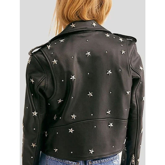 A person viewed from the back wearing a black leather jacket adorned with silver star-shaped studs, paired with blue jeans against a light gray studio background.