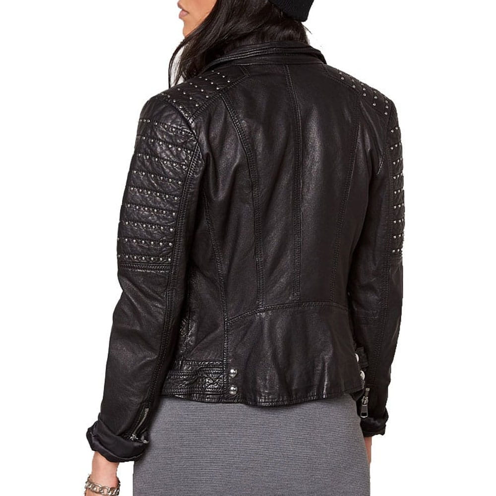A woman shown from the back wearing a black leather jacket with silver studded details on the shoulders and sleeves, paired with a gray skirt against a white background.