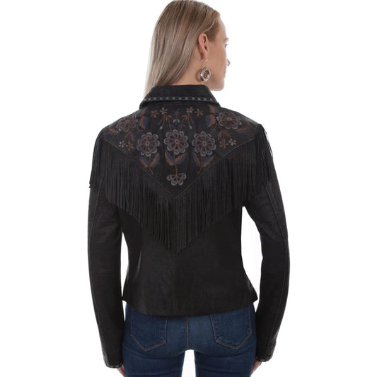 A woman shown from the back wearing a black western-style fringe jacket with floral embroidery across the shoulders, paired with blue jeans against a plain white background.