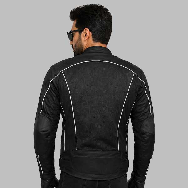 A man viewed from the back wearing a black motorcycle jacket with white contrast stitching and black leather elbow patches, set against a solid gray background.