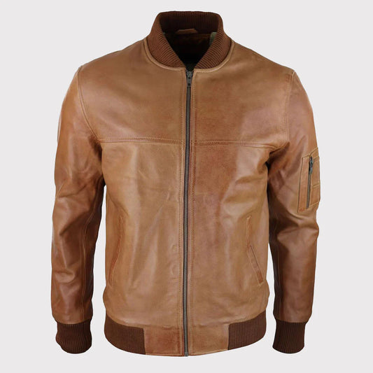 A tan leather bomber jacket with a ribbed brown collar, cuffs, and hem, featuring a front zipper and a zippered sleeve pocket, shown against a light gray background.